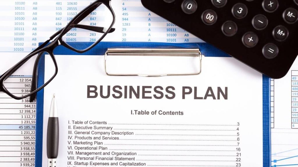 Business plan with calculator and glasses