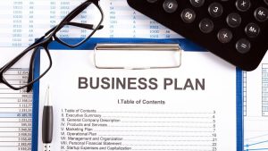 NYDA Business Plan Template — Free Download for Young Entrepreneurs Business plan with calculator and glasses